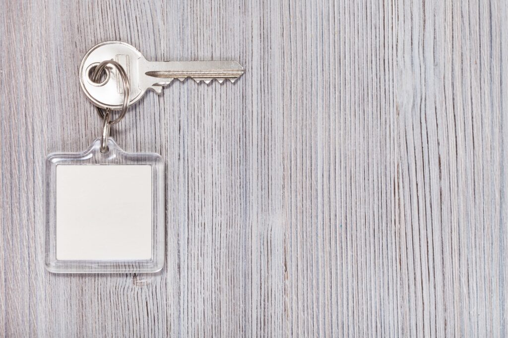 key with key chain on wooden background